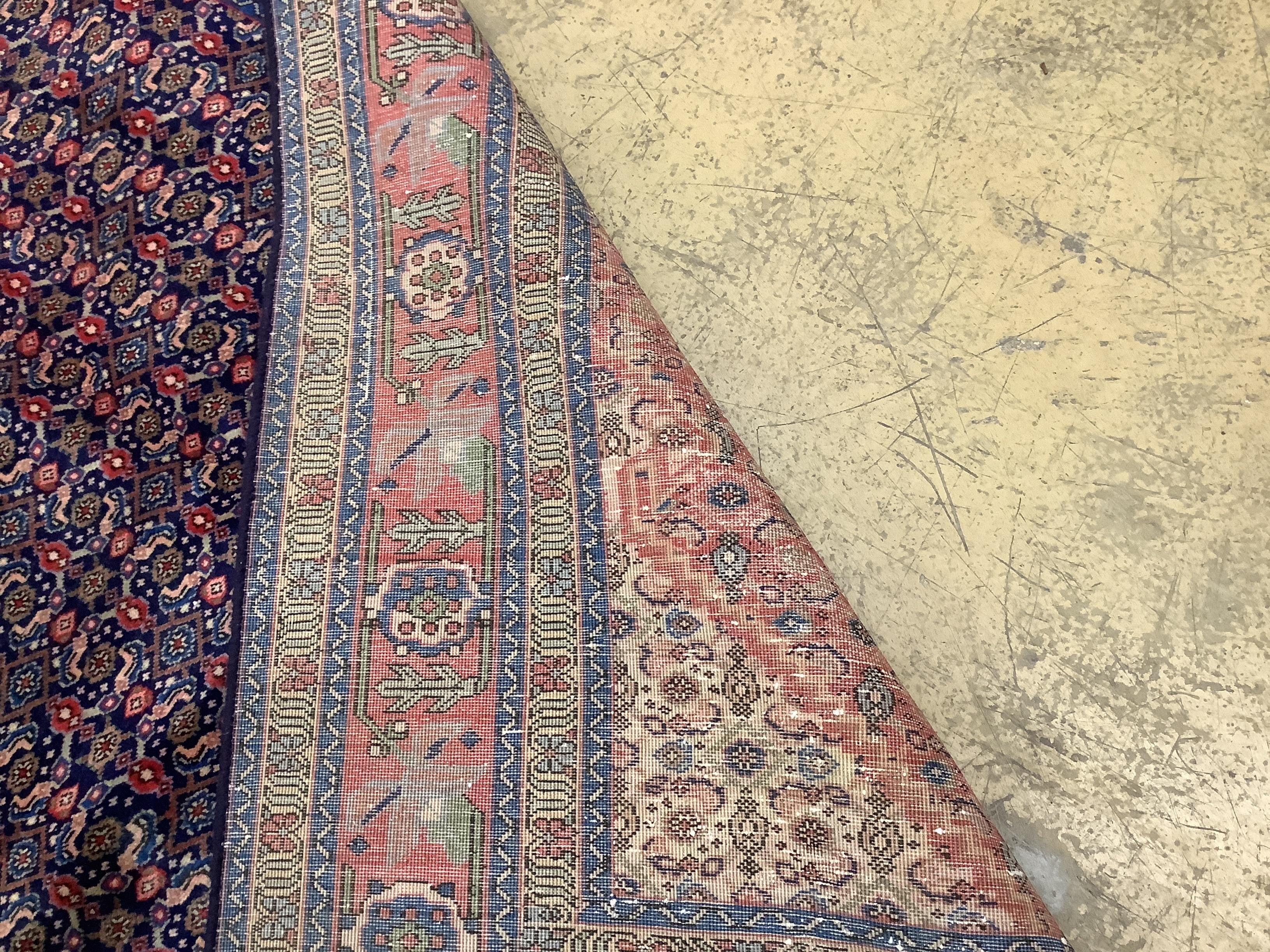 A Tabriz red ground carpet, 296 x 189cm